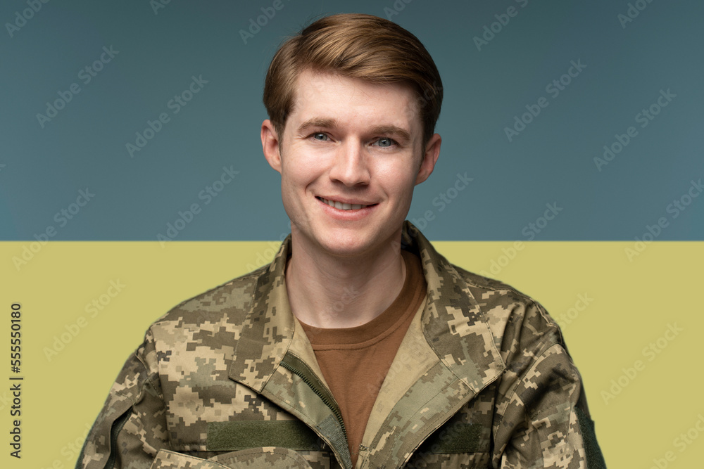 Young caucasian man wearing camouflage army uniform happy face smiling Young caucasian man wearing camouflage army uniform happy face smiling