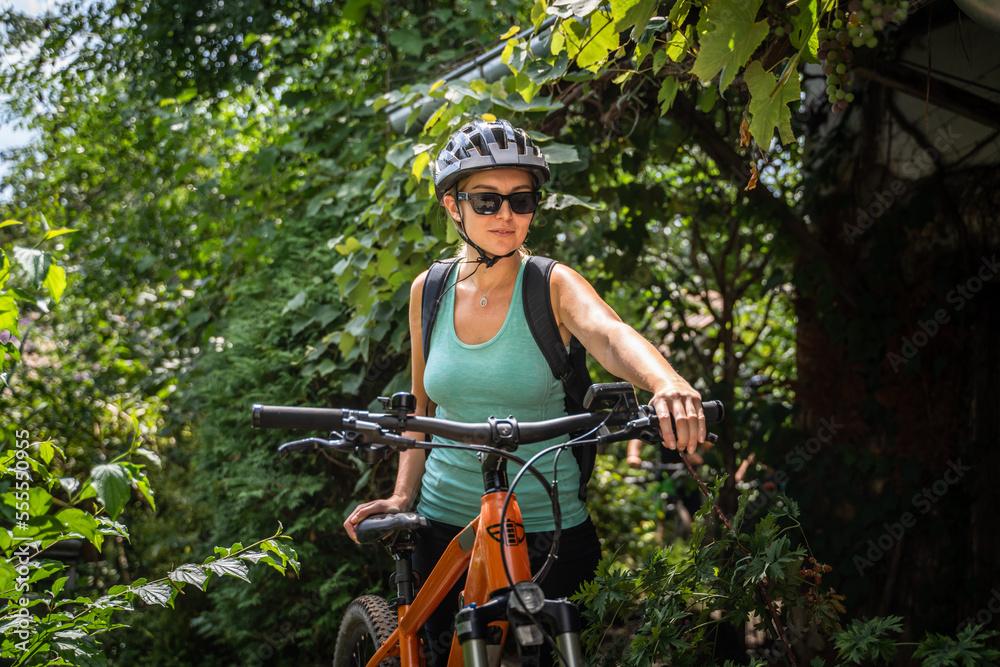 Φωτογραφία One woman caucasian female ride electric bicycle e-bike in summer day