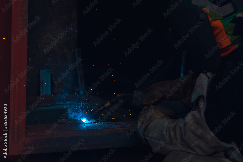 Welder building technical, industrial steel welder in technical workshop, craftsman, industrial steel welder, technical steel in technical factory, Welding of steel, sparking,light color like firework Welder building technical, industrial steel welder in technical workshop, craftsman, industrial steel welder, technical steel in technical factory, Welding of steel, sparking,light color like firework
