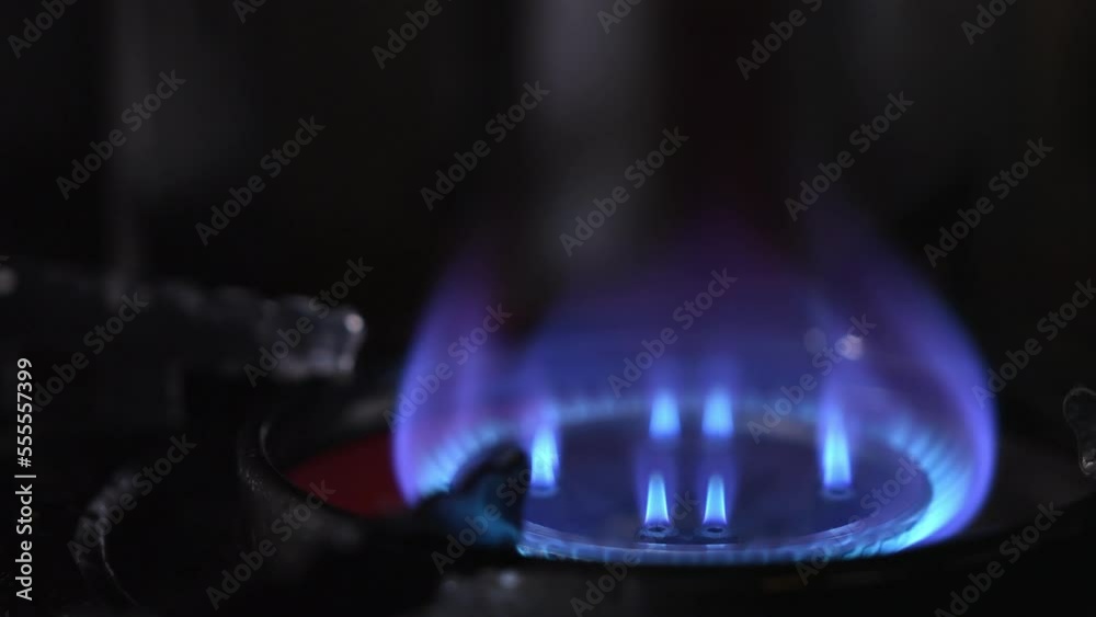 Macro video of a gas burner. Ignition, combustion and attenuation of domestic gas on the stove in the house, on a dark background. Detailed video of gas burning in a stove. gas stove for cooking Macro video of a gas burner. Ignition, combustion and attenuation of domestic gas on the stove in the house, on a dark background. Detailed video of gas burning in a stove. gas stove for cooking