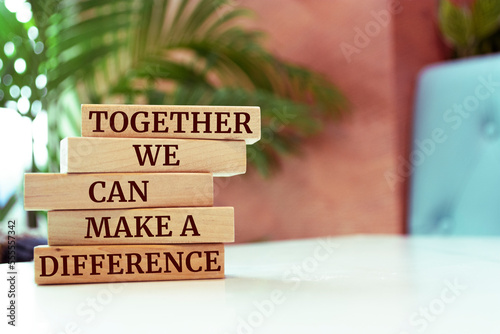 Wooden blocks with words 'Together We Can Make A Difference'. photo