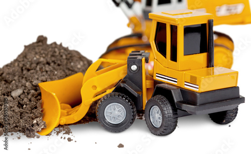 Yellow toy Bulldozer works with dirt