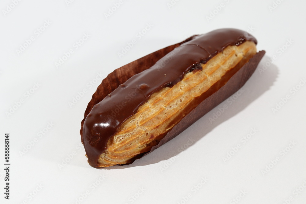 A chocolate eclair on a white background