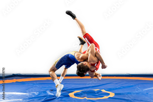 The concept of fair wrestling. Two greco-roman wrestlers in red and blue uniform wrestling on a wrestling carpet