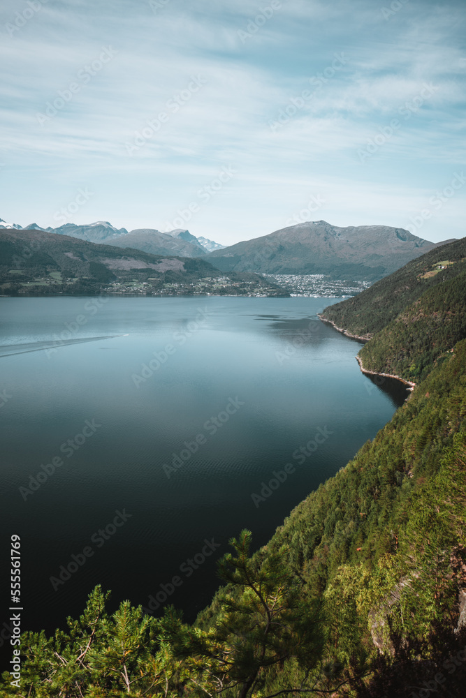 Mountains during moody weather in autumn Norway with a fjord and beautiful reflections Background Mountains during moody weather in autumn Norway with a fjord and beautiful reflections Background