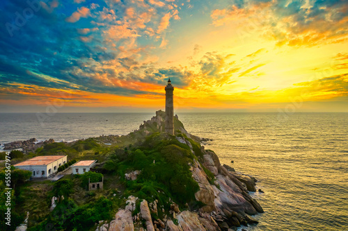 Landscape of small island with ancient lighthouse at sunrise sky is beautiful and peaceful. This is only ancient lighthouse is located on island in Vietnam