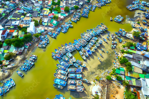 La Gi fishing village seen from above with hundreds of boats anchored along both sides of river to avoid storms near estuary, this is also a large fishing port providing seafood in central Vietnam