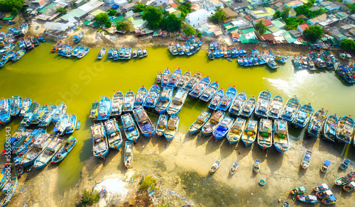 La Gi fishing village seen from above with hundreds of boats anchored along both sides of river to avoid storms near estuary, this is also a large fishing port providing seafood in central Vietnam