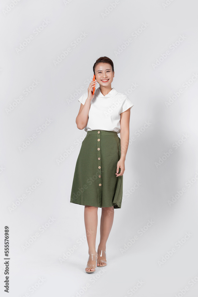 Excited amazed charming woman talking on mobile phone, isolated over white background. Excited amazed charming woman talking on mobile phone, isolated over white background.
