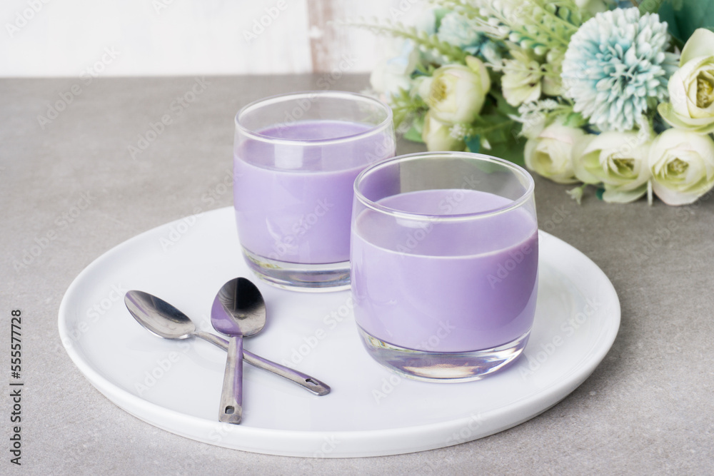 Homemade sweet taro silky pudding in a glasses cup and placed on a white plate. Healthy snacks ready to eat Homemade sweet taro silky pudding in a glasses cup and placed on a white plate. Healthy snacks ready to eat