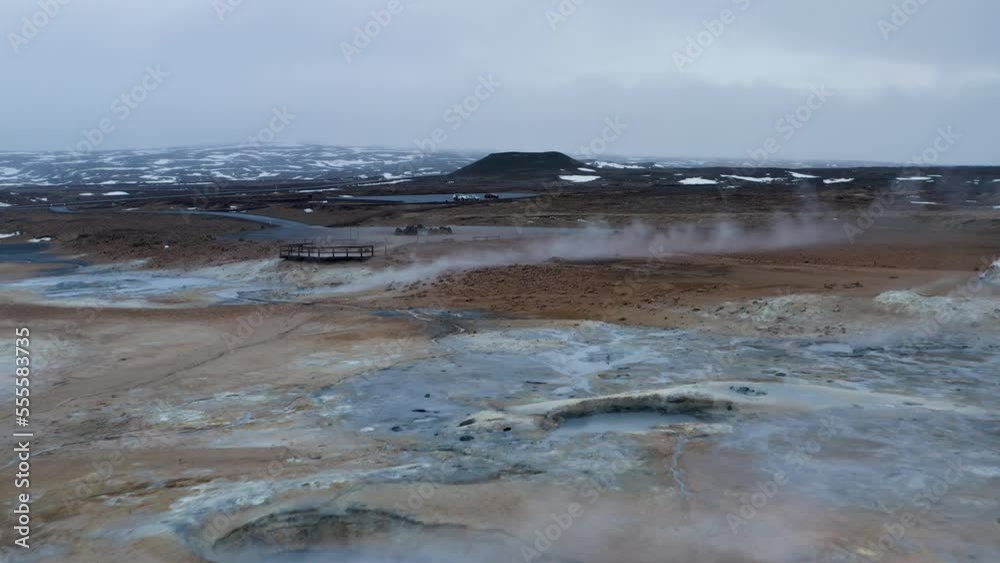 Low altitude flight over boiling field of geothermal mud pools and landscape in Iceland Low altitude flight over boiling field of geothermal mud pools and landscape in Iceland