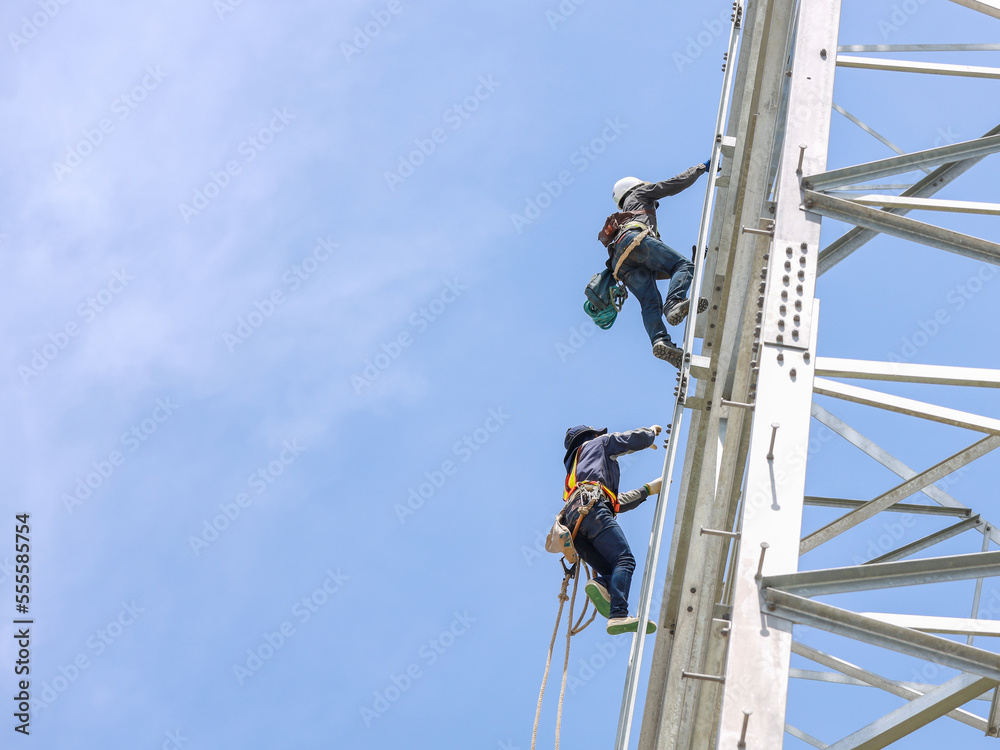 Lineman climbing on transmission line tower