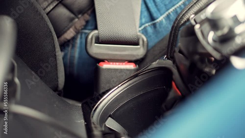 Wallpaper Mural driver fastening seatbelt in car . safety roadtrip in auto using seat belt Torontodigital.ca