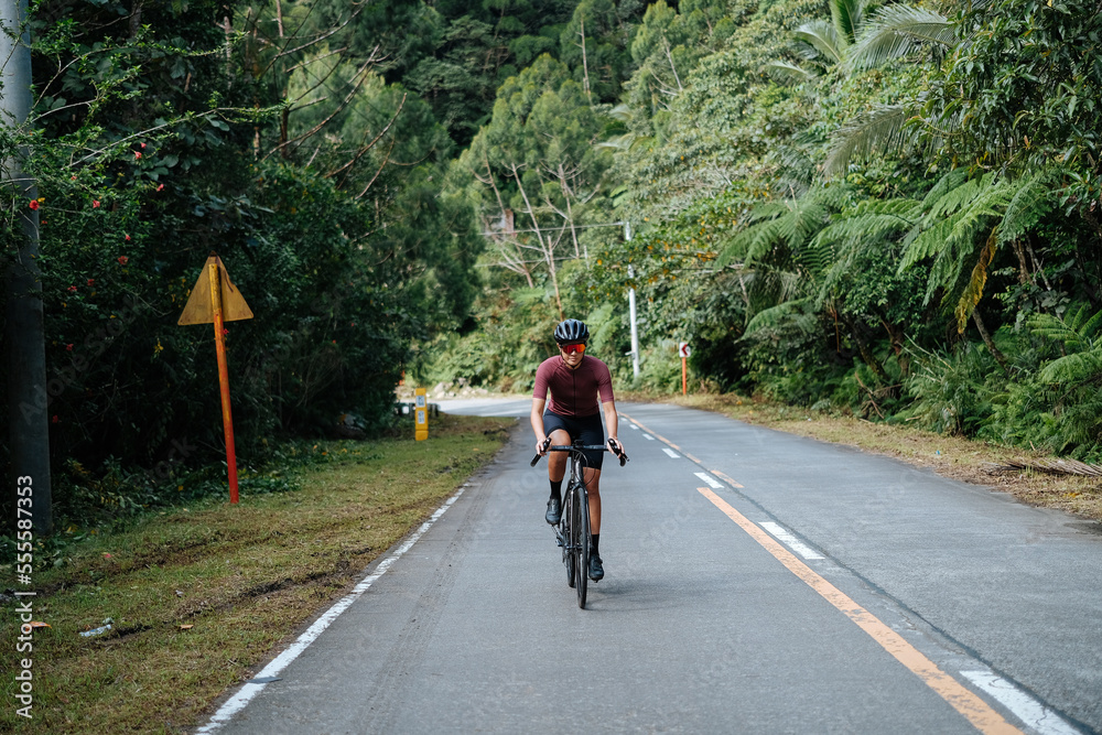 A young female cyclist riding her gravel bike in the mountains. A young female cyclist riding her gravel bike in the mountains.