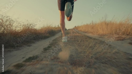 Marathon and triathlon athlete training by running photo