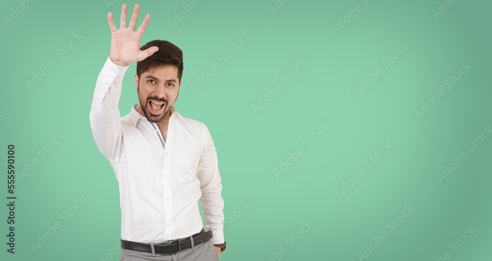 Excited Man. Man jumping with joy on a green background. Excited Jumping Man Showing hand. Indian or Pakistani or Asian Man. Happy Customer. High five hand. Young guy in white shirt. man with hands up Excited Man. Man jumping with joy on a green background. Excited Jumping Man Showing hand. Indian or Pakistani or Asian Man. Happy Customer. High five hand. Young guy in white shirt. man with hands up