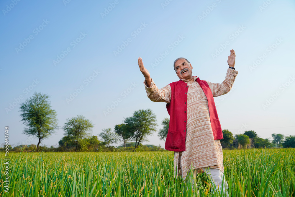 Indian farmer giving expression at onion agriculture field.