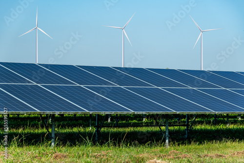 Solar panels and wind turbines open filed alternative EcoPower electricity  solar energy and wind energy hybrid power plant systems station use renewable energy to generate power concept. photo