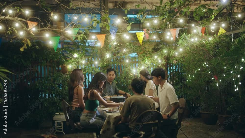 Asian people having a barbecue party and drinking beer.