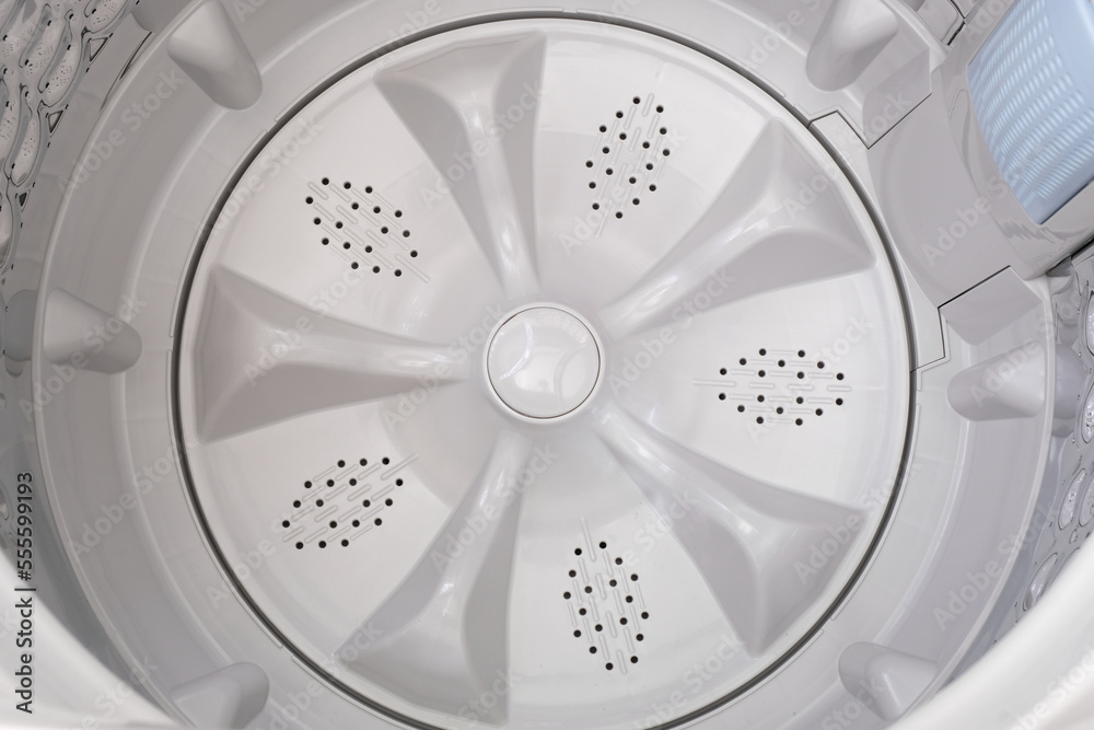 Inside of a top load washing machine showing the washing tub with