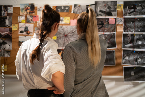 Wallpaper Mural Smart detectives looking attentively at investigation board, evaluating clues, teamwork in private detective agency Torontodigital.ca