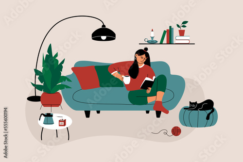 Woman reading book. Cartoon character sitting on sofa at home with literature and coffee cup. Flat vector illustration