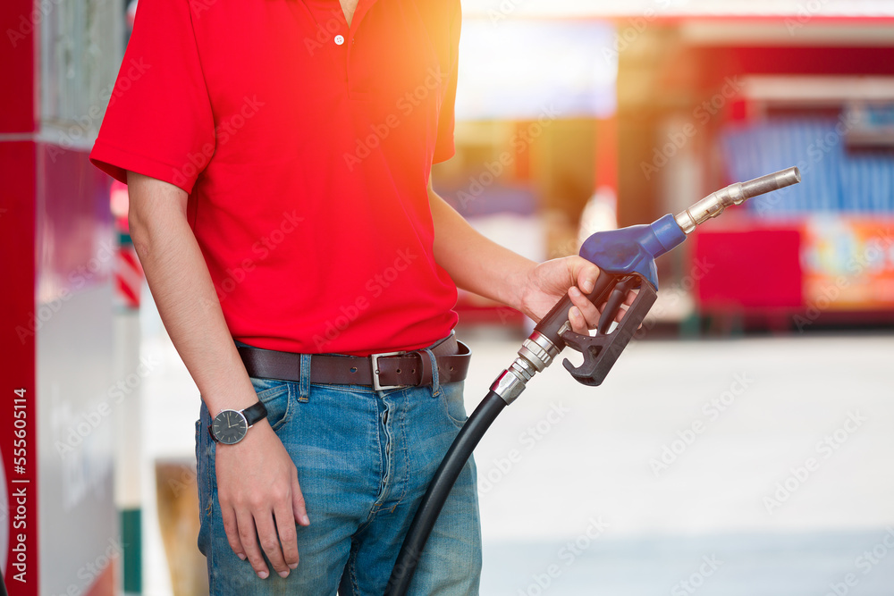 Hands of attendant service male worker refuelling car at gas station. Assistant worker refuelling car at petrol station Hands of attendant service male worker refuelling car at gas station. Assistant worker refuelling car at petrol station