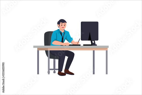 Cute Young Guy Sitting at Desk and Working on Computer.