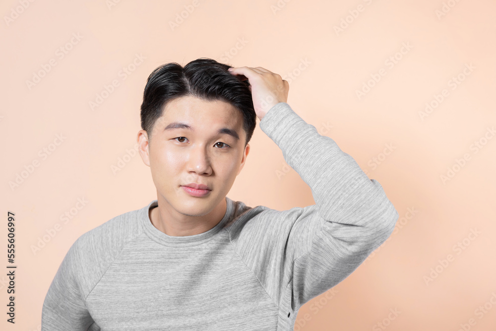 young man touching his hair young man touching his hair