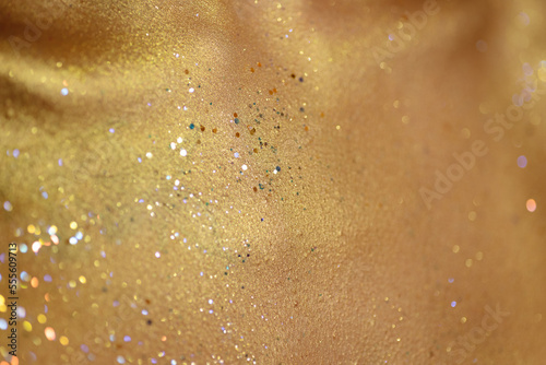 Closeup human skin with golden makeup. Selected focus with depth of field.