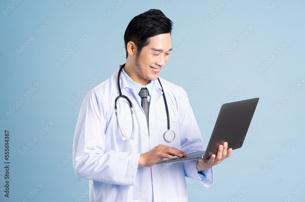 Asian male doctor portrait on blue background Asian male doctor portrait on blue background