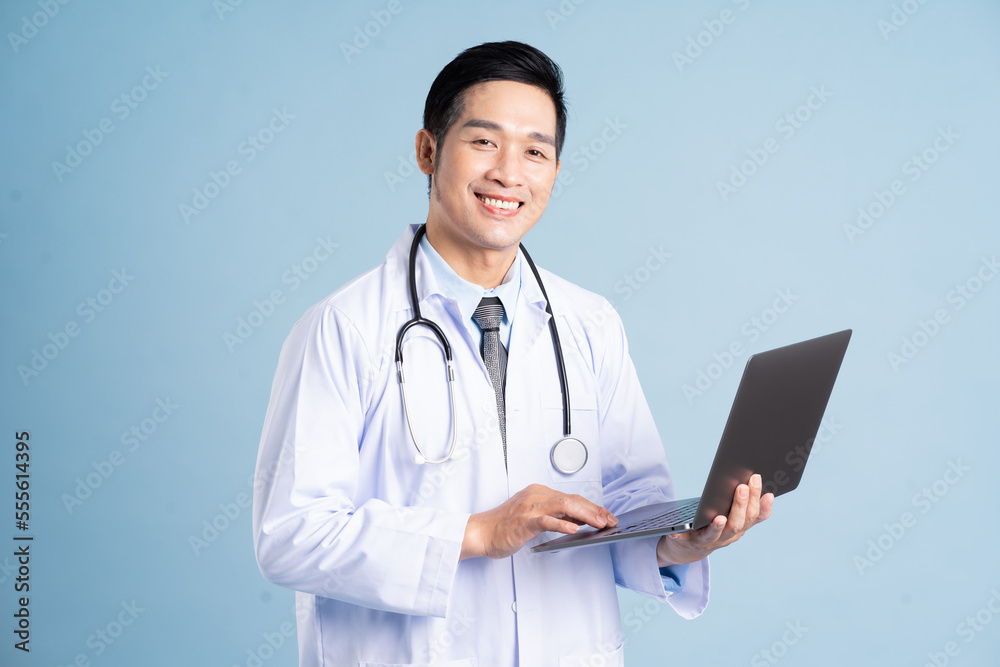 Asian male doctor portrait on blue background Asian male doctor portrait on blue background
