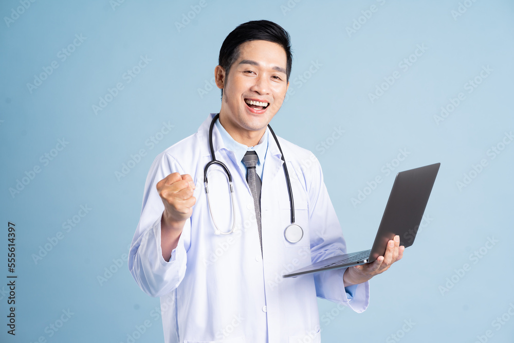 Asian male doctor portrait on blue background Asian male doctor portrait on blue background