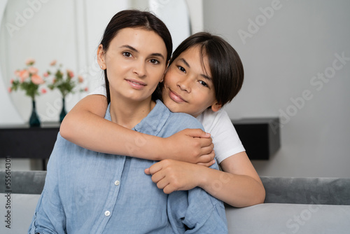 Portrait of asian boy hugging mother at home © LIGHTFIELD STUDIOS