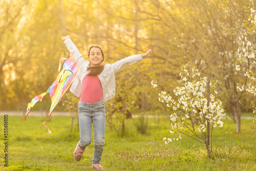 little cute girl flying a kite on a sunny day
