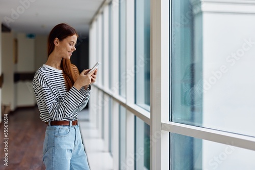 Woman with phone in hand online shopping from home, the concept of technology and saving time via smartphone internet, the copy space Free Download Woman with phone in hand online shopping from home, the concept of technology and saving time via smartphone internet, the copy space - GFXLoad
