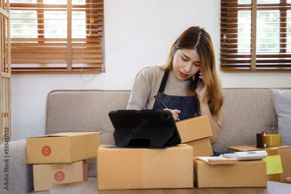 young asian women using smartphone contacted a customer asking for a shipping address. young asian women using smartphone contacted a customer asking for a shipping address.