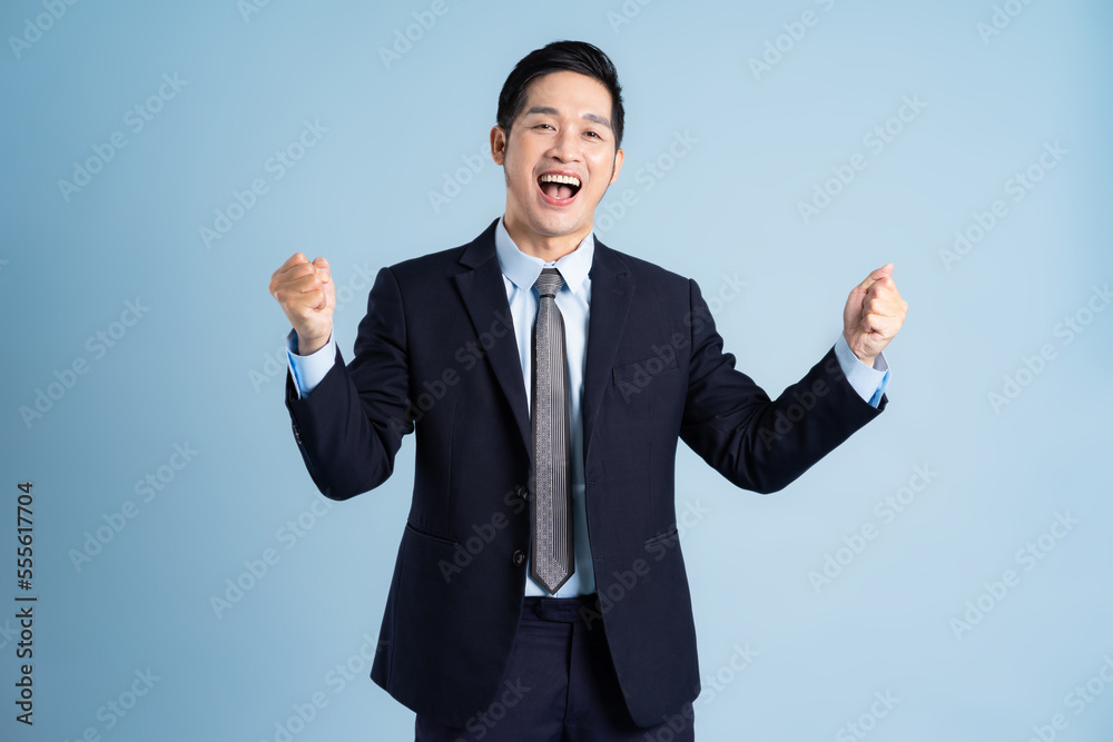 portrait of asian businessman wearing suit on blue background portrait of asian businessman wearing suit on blue background