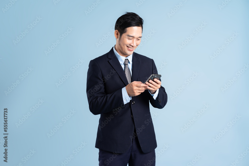 portrait of asian businessman wearing suit on blue background portrait of asian businessman wearing suit on blue background
