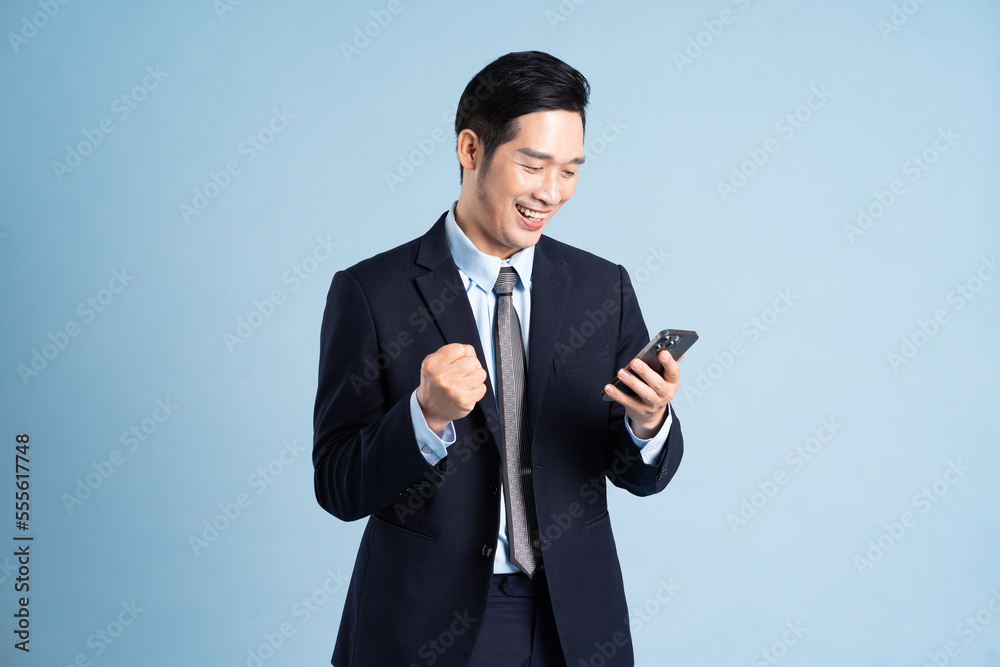 portrait of asian businessman wearing suit on blue background portrait of asian businessman wearing suit on blue background