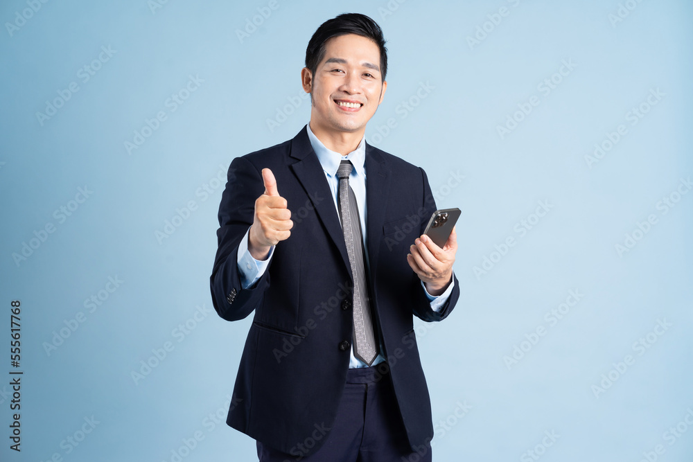portrait of asian businessman wearing suit on blue background portrait of asian businessman wearing suit on blue background