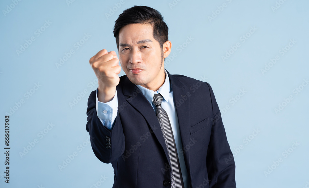 portrait of asian businessman wearing suit on blue background portrait of asian businessman wearing suit on blue background