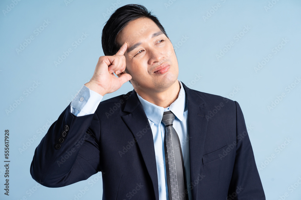 portrait of asian businessman wearing suit on blue background portrait of asian businessman wearing suit on blue background