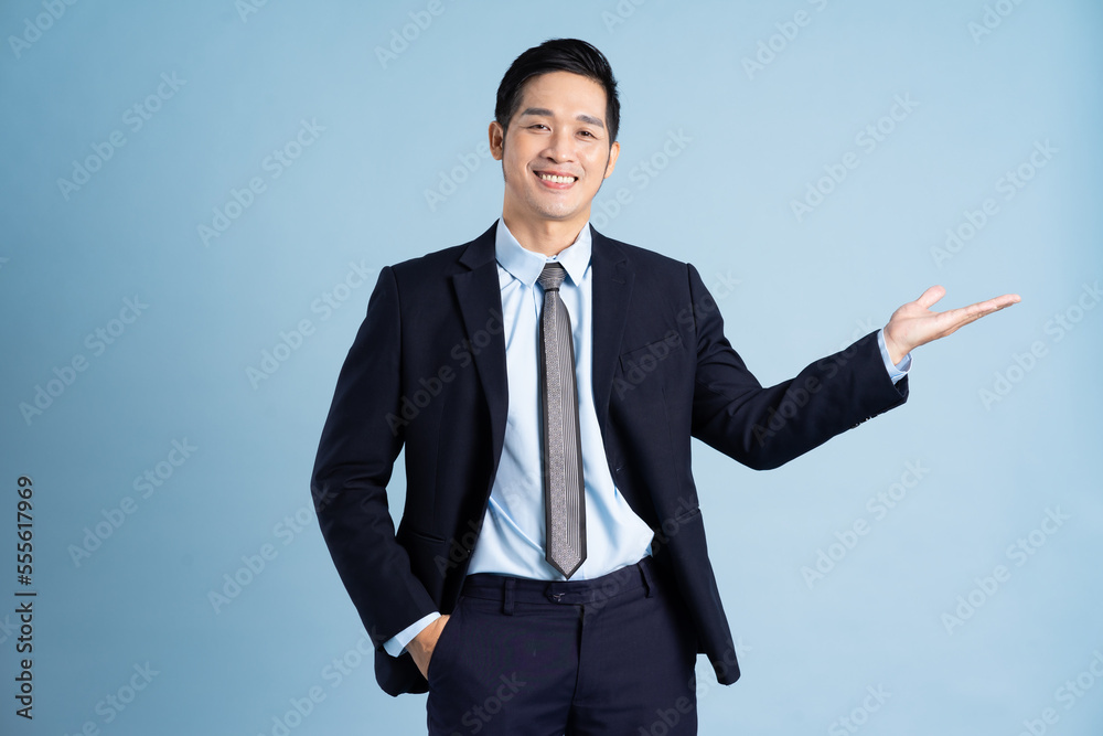 portrait of asian businessman wearing suit on blue background portrait of asian businessman wearing suit on blue background