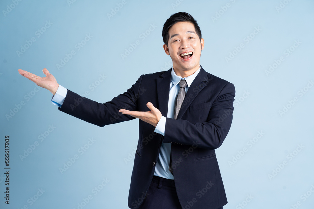 portrait of asian businessman wearing suit on blue background portrait of asian businessman wearing suit on blue background