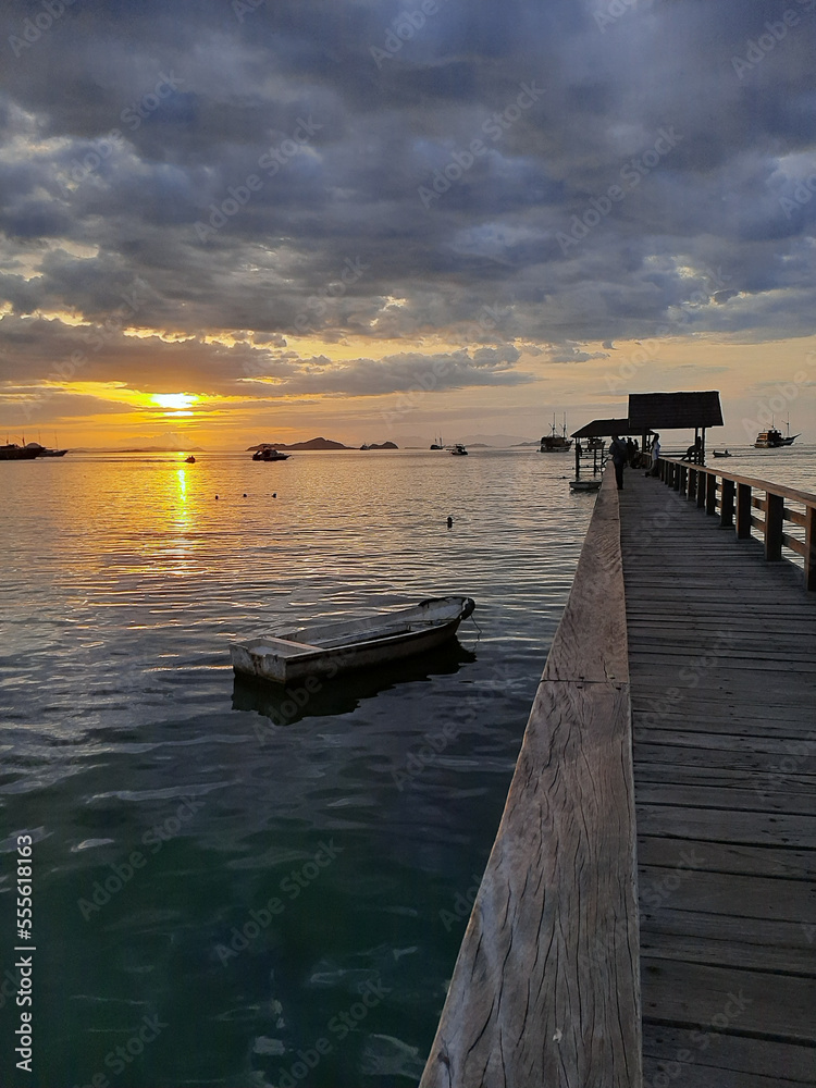 Fototapeta premium sunset on the pier at Pede beach