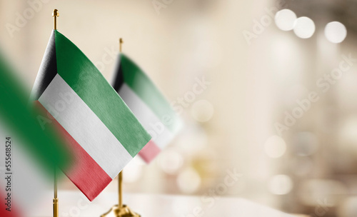Small flags of the Kuwait on an abstract blurry background