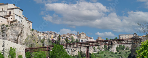 horizontal panorama of the city of Cuenca from the Huecar river with blue sky with clouds in the background photo