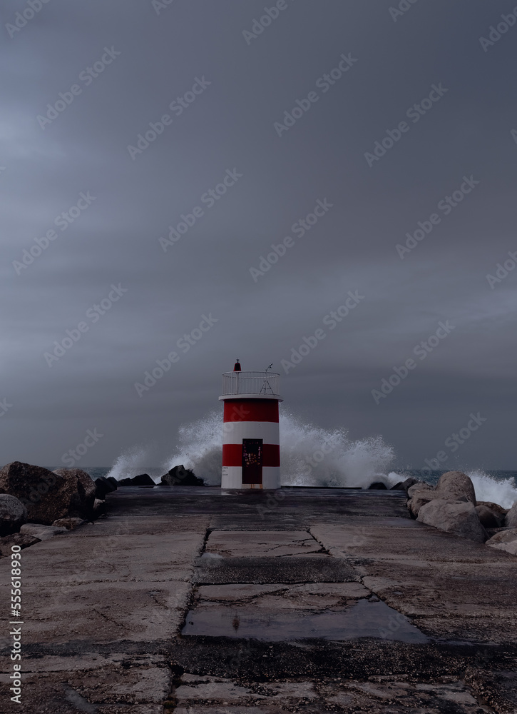 lighthouse over the coast of the atlantic ocean in the background