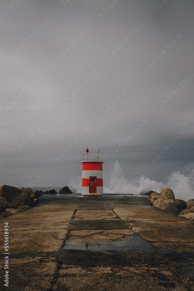 lighthouse over the coast of the atlantic ocean in the background